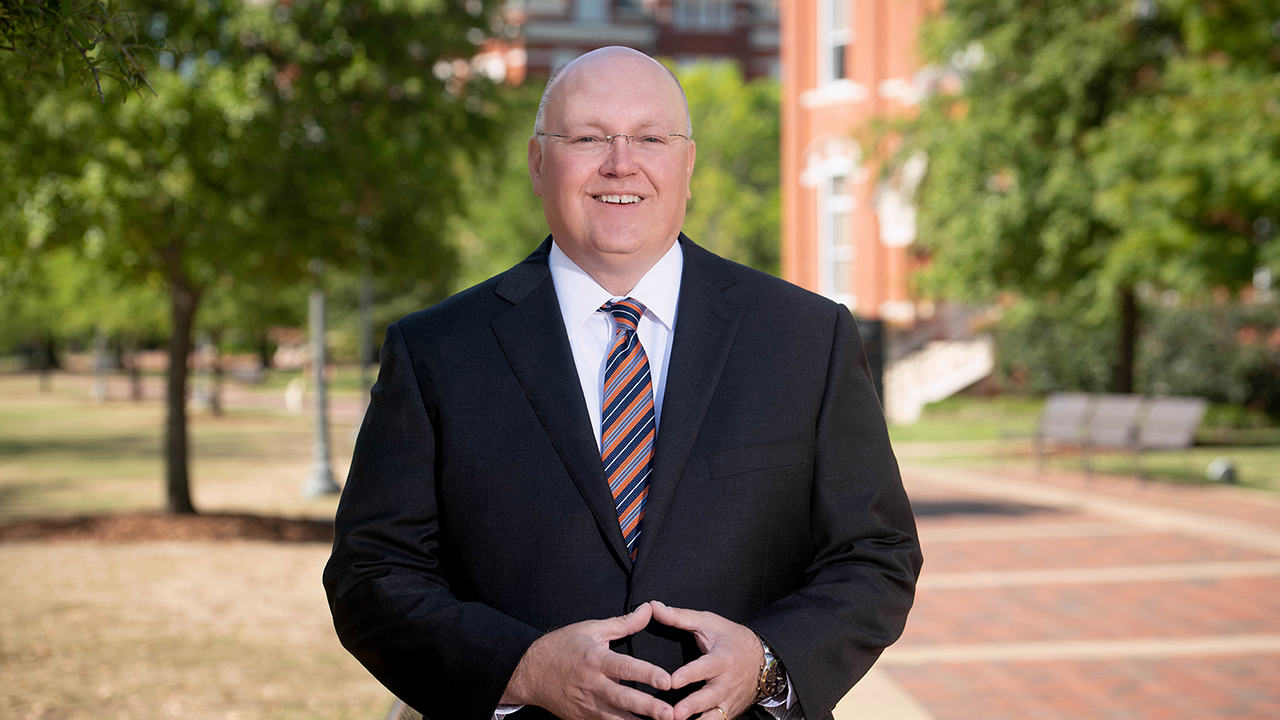 Auburn University President Christopher B. Roberts is pictured on a walkway in Samford Park.