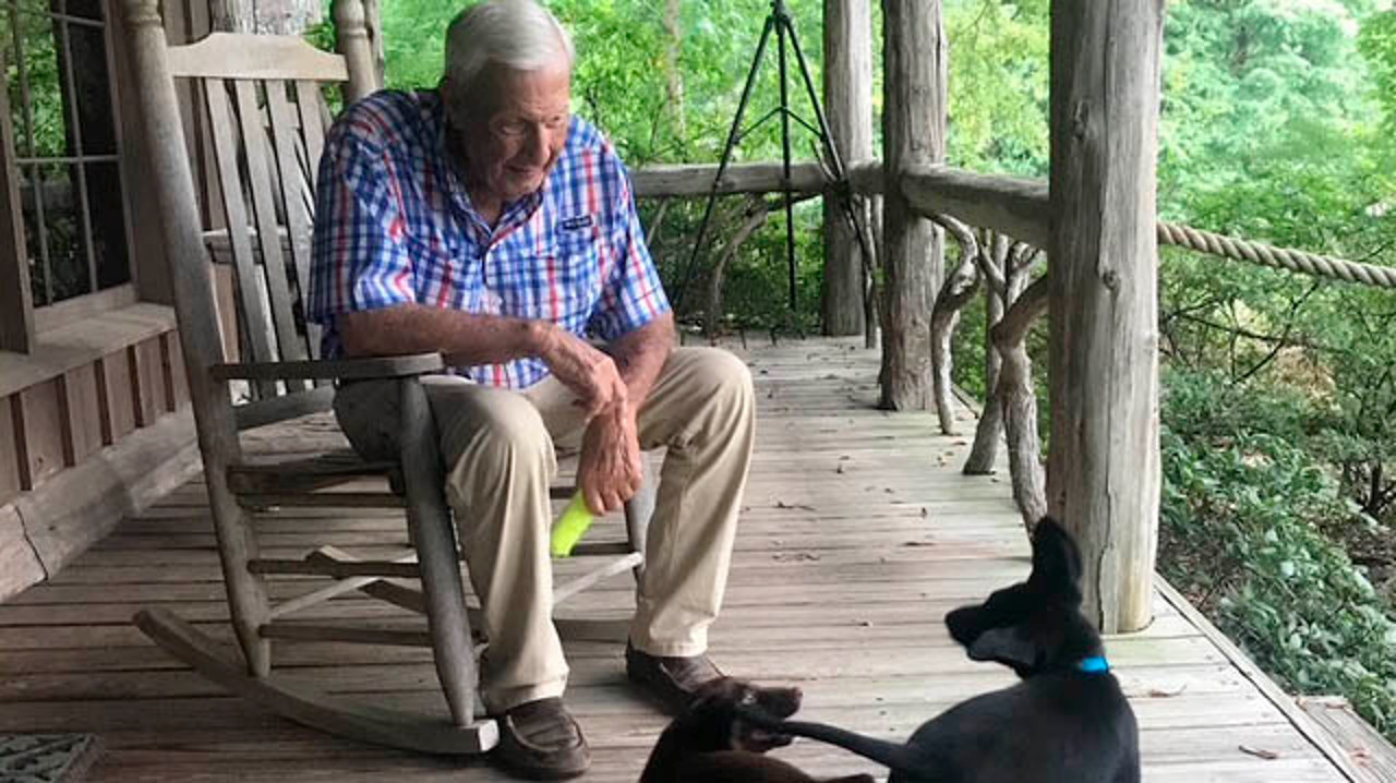 Legendary Auburn football coach Pat Dye and two puppies on his porch at his Crooked Oaks estate