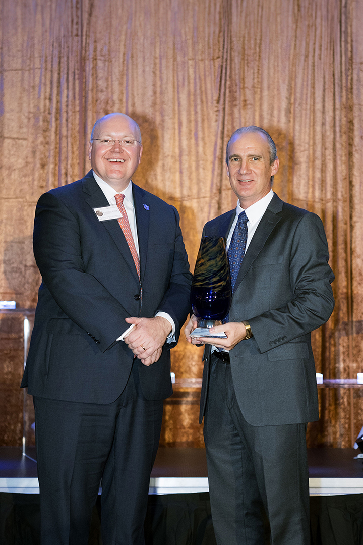 Steve Brown accepts award from President Roberts