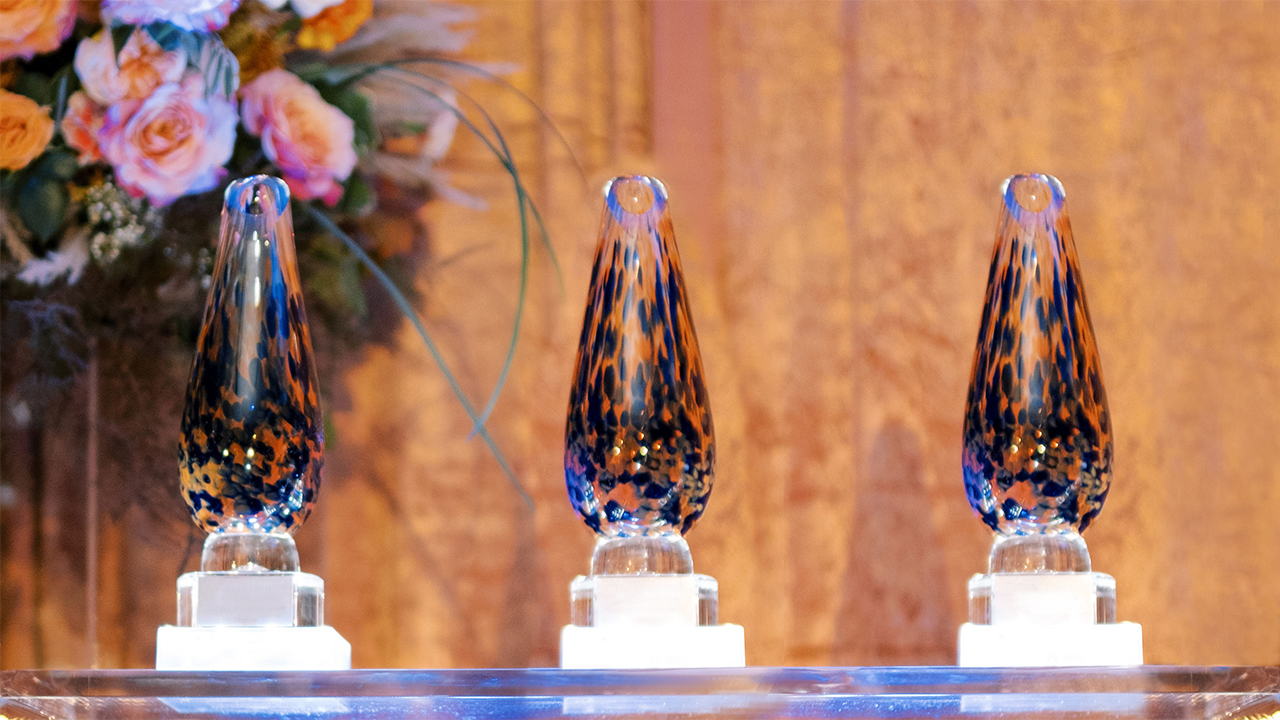 Faculty Awards with Floral Arrangements in Background