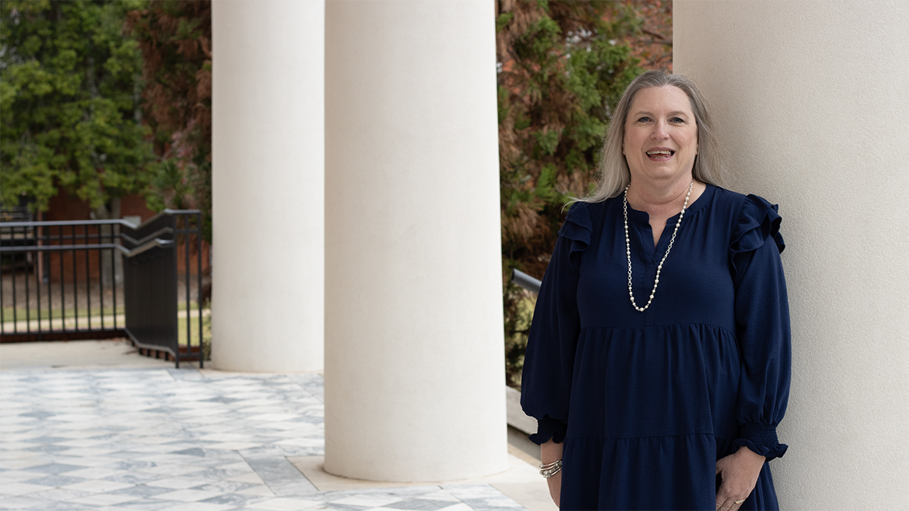 Judy Sanders standing on the steps of Langdon Hall