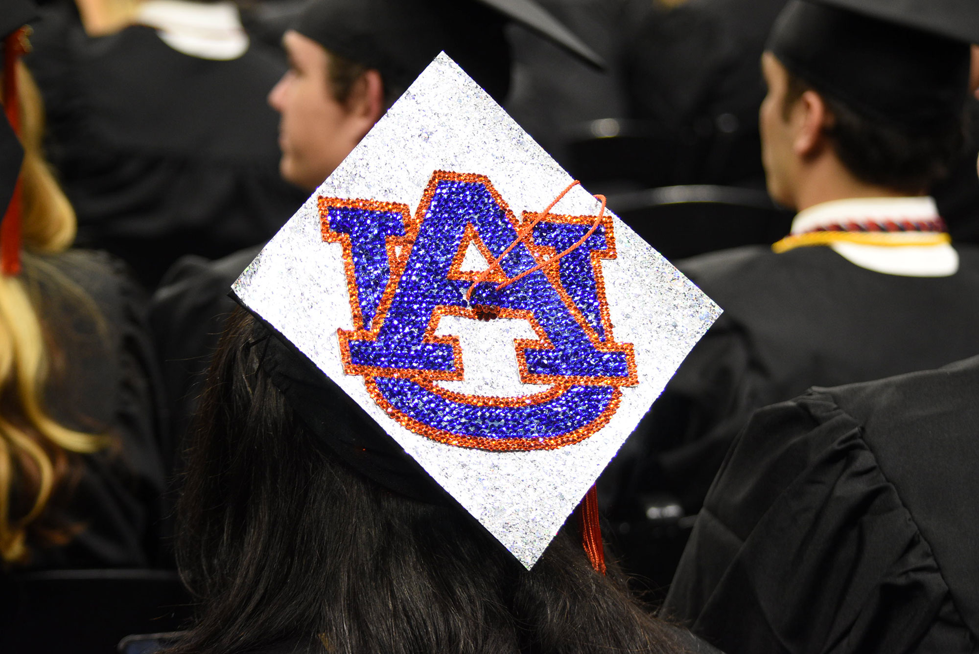 A graduation cap with the interlocking AU bedazzled on top