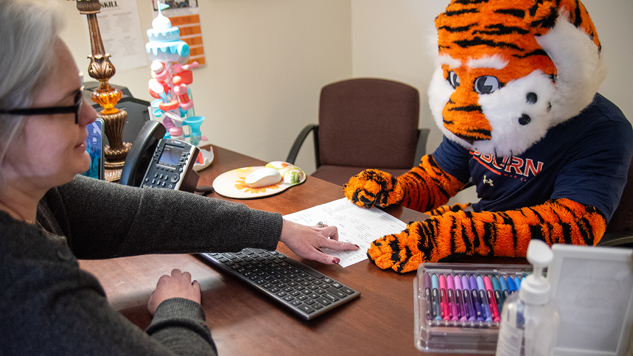 Aubie seated at desk with mentor