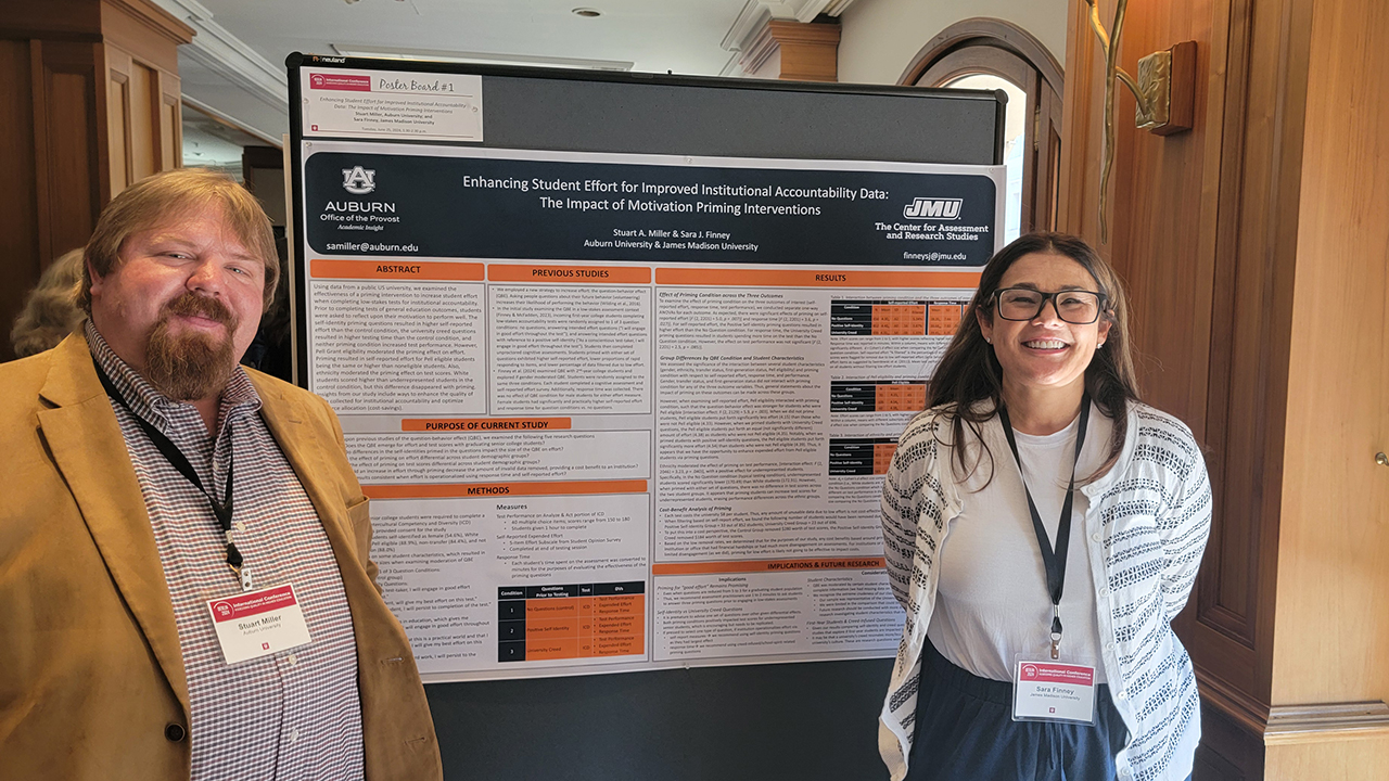 Two people standing in front of research poster