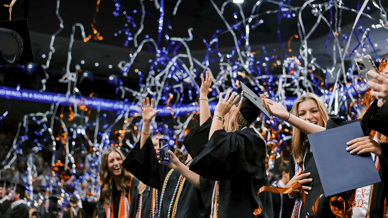 Confetti surrounding Auburn graduates
