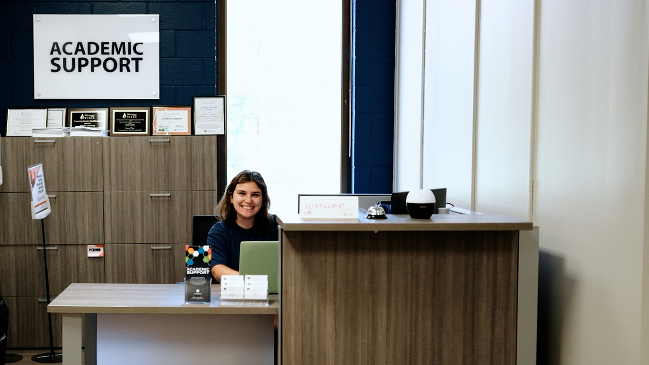 Student employee sitting at desk in Academic Support Offices